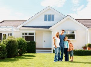 family standing in front of a house