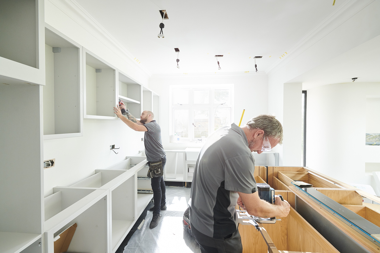 two joiners installing a kitchen